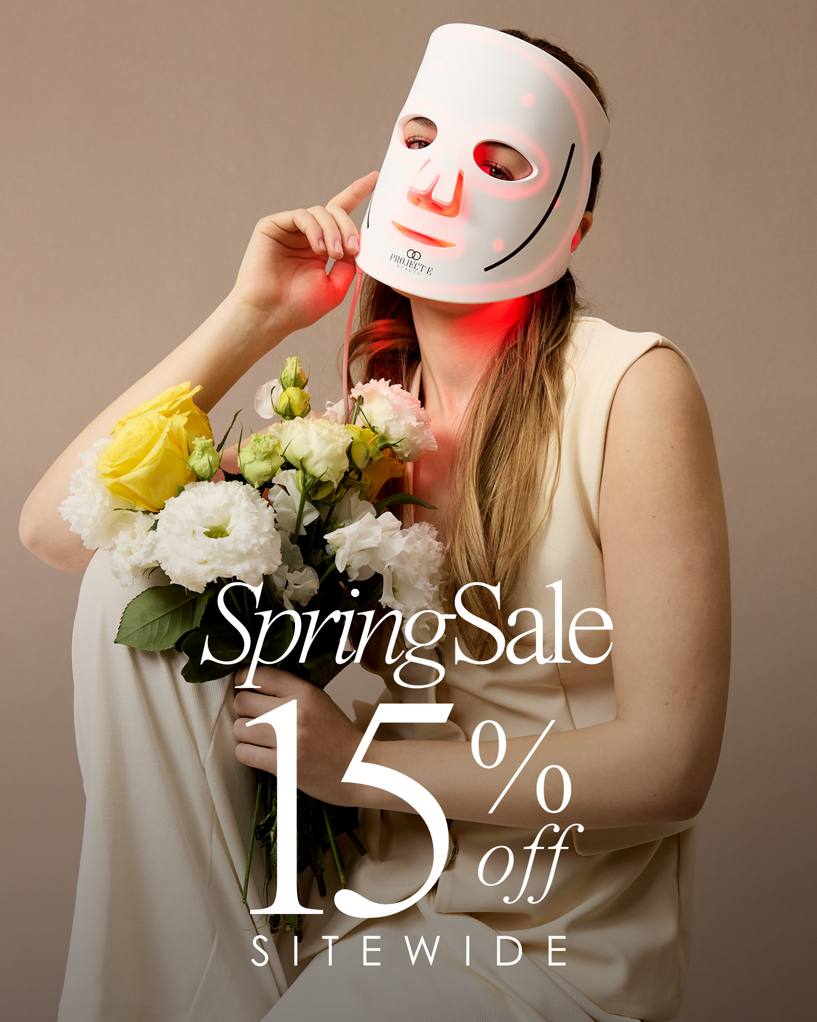 Woman showcasing LumaLux Pro LED face mask in professional photoshoot.