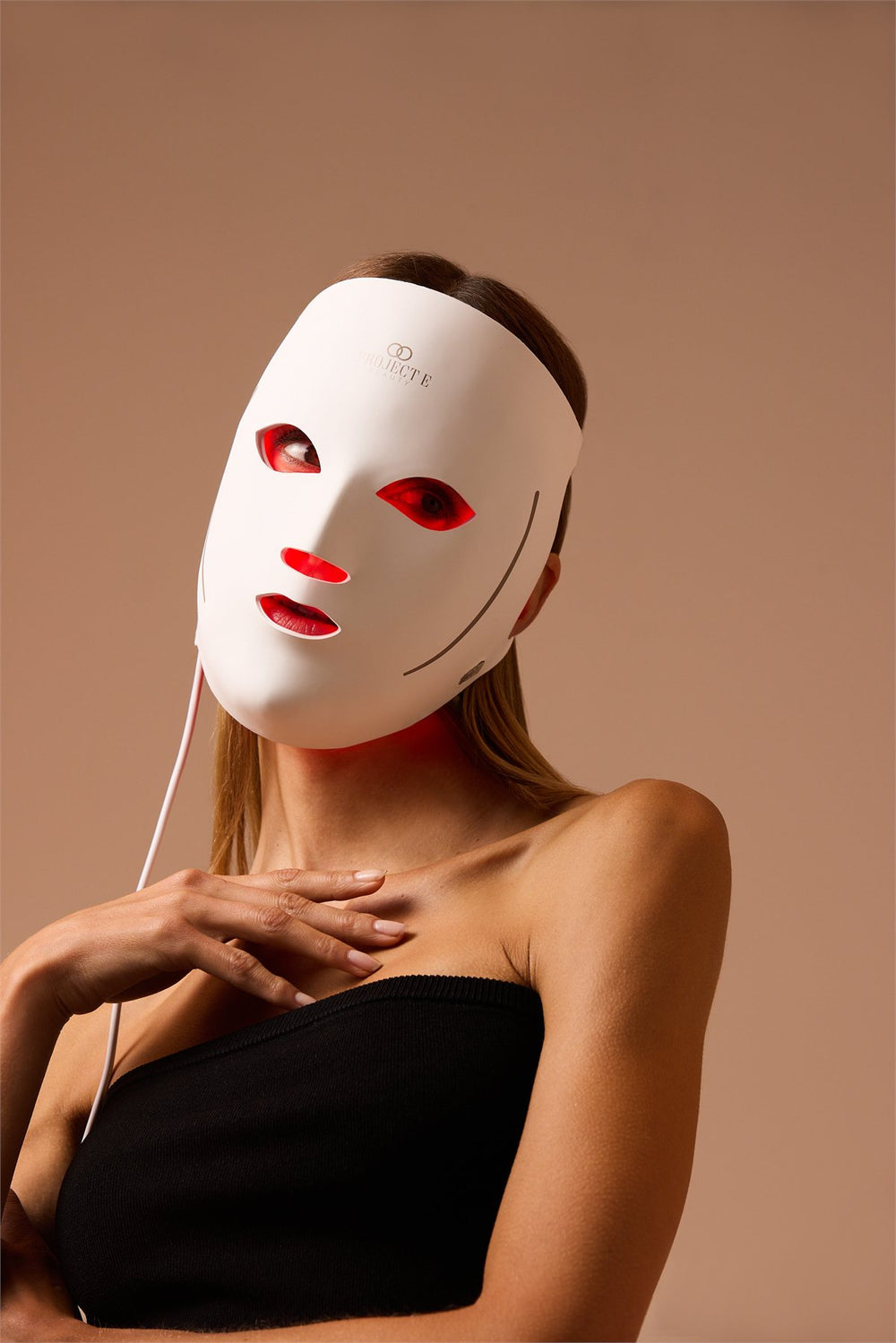 Woman wearing the LumaLux Face V2 LED red light therapy mask